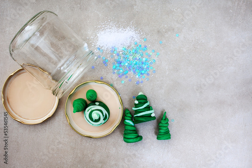 Kid Christmas activity. Homemade snow globe made from empty jar, glitter and polymer clay