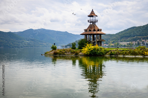 Danubian landscape. Old lighthouse, building on the bank of the Danube. Autumn on the Danube. Reflections in the water. photo