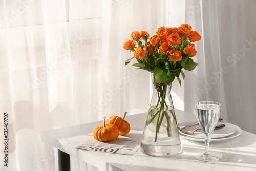 Vase with beautiful roses a...