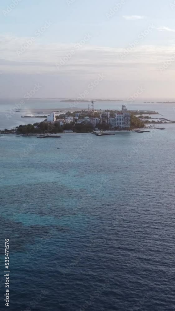 An aerial view of Maafushi Island in the Maldives after sunset. Vertical video. An aerial view of Maafushi Island in the Maldives after sunset. Vertical video.