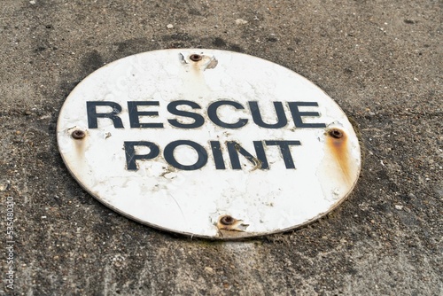 Rescue point sign attached to a sea wall in a coastal town in the UK photo