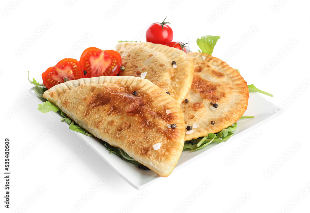 Plate with tasty chebureks and vegetables on white background
