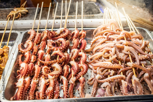 Squid skewers at Jiefangbei Food Street in Chongqing, China photo