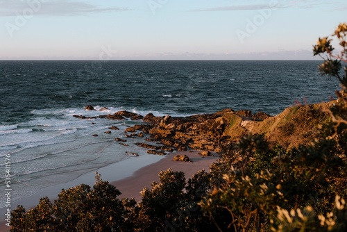 Rocky shore of Little Wategos Beach in Byron Bay, Australia photo