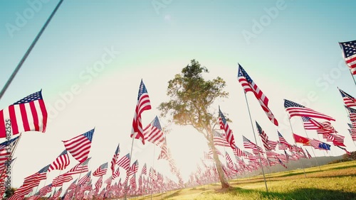 View on Waves of Flags on annual ceremony at Pepperdine University, CA, USA. Shot of honoring the lives lost in the terror attacks on September 09,11, 2001. Backlight flare. High quality 4k footage photo