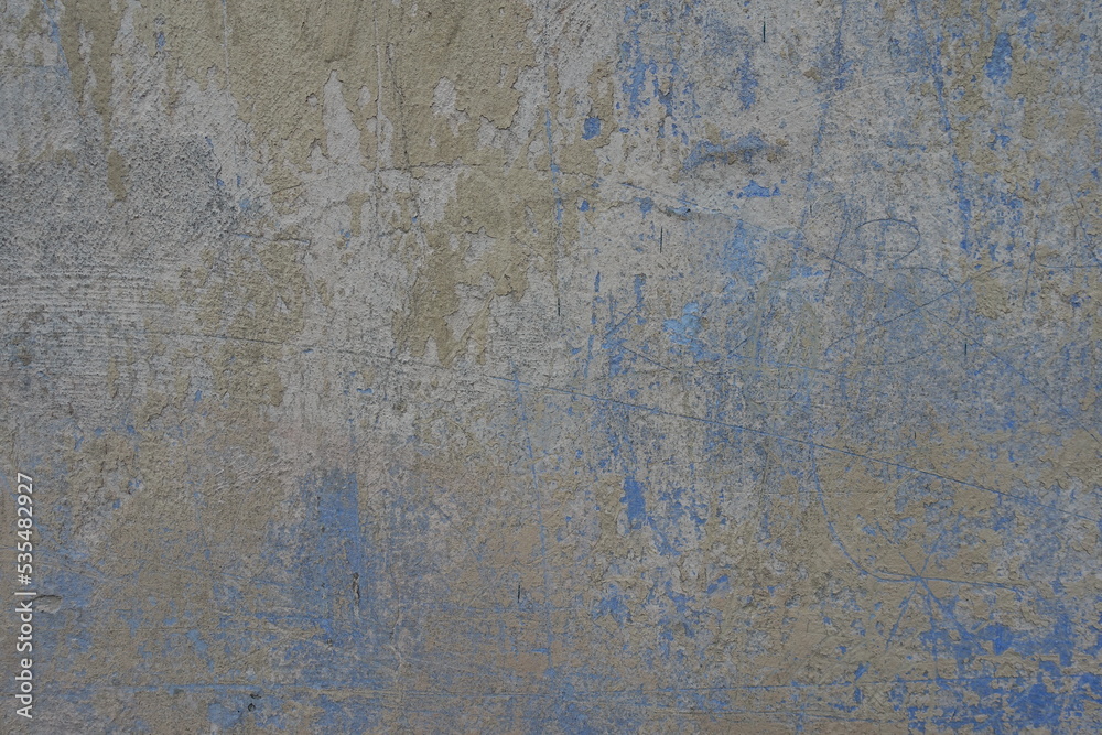 Backdrop - beige and blue old, faded and scratched painted wall