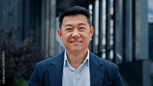 Fotografie Close up front view in city outdoors Asian Korean man business boss leader compa