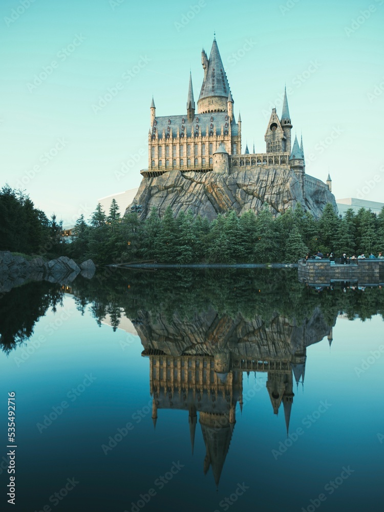 Fototapeta premium Vertical shot of a lake reflecting the Alnwick Castle in England