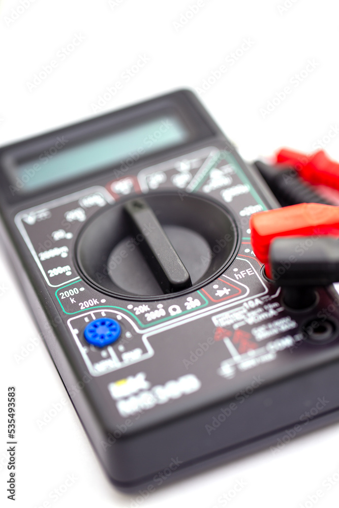 Digital multimeter and probes on white background