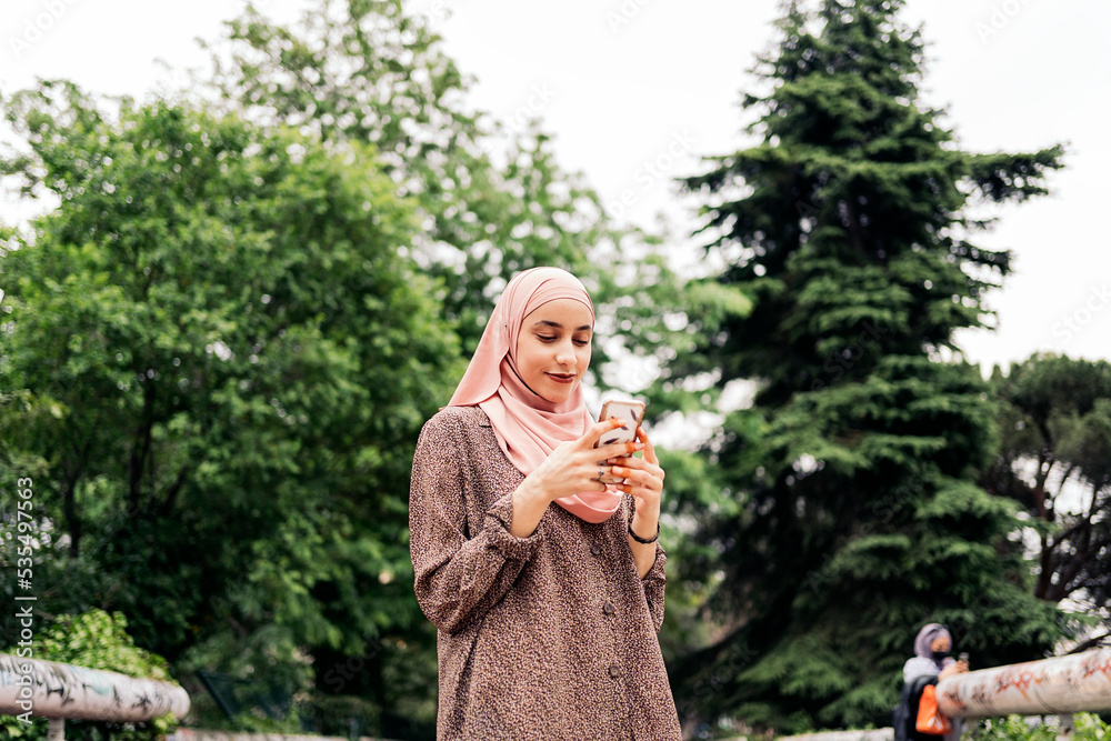 Fototapeta premium Happy Muslim Woman Using Cellphone