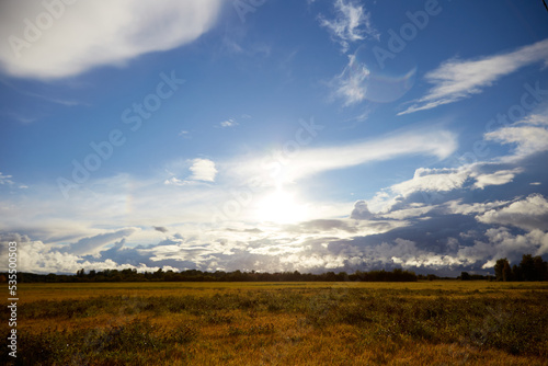 View on the road and agricultural field and beautiful sky covered with white clouds