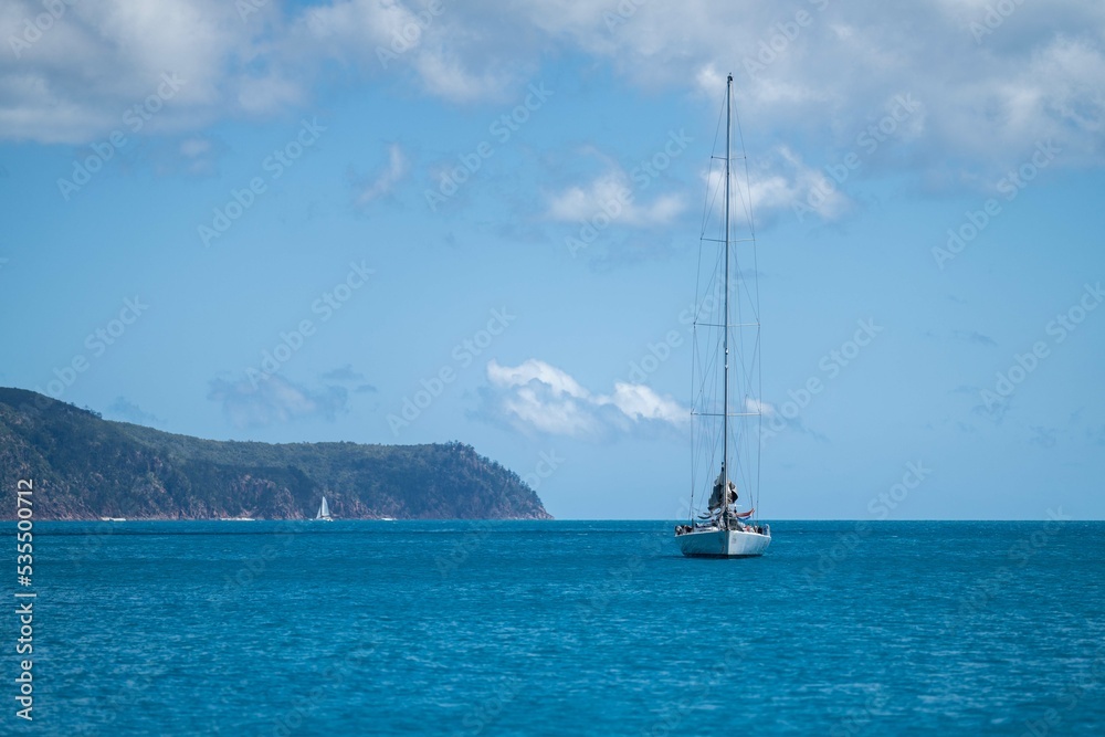 tourist boats and tour boats in the whitsundays queensland, australia. travellers on the great barrier reef, over coral and fish. tourism yachts of young people partying on the water tourist boats and tour boats in the whitsundays queensland, australia. travellers on the great barrier reef, over coral and fish. tourism yachts of young people partying on the water