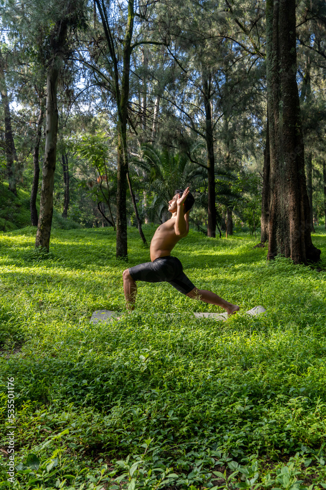 mexican man doing yoga and stretching in the forest, mexico