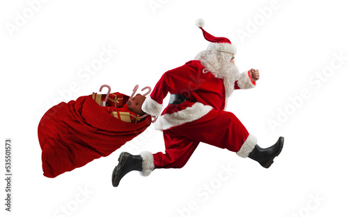 Santa claus runs fast to deliver all gifts photo