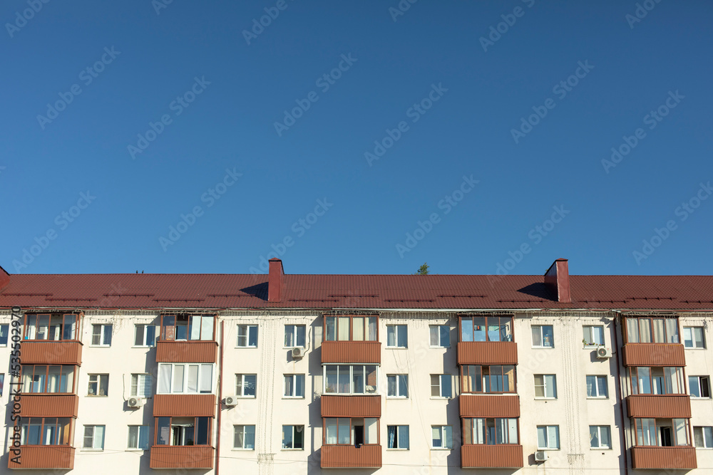 Building in city. House with apartments. Facade of residential building.