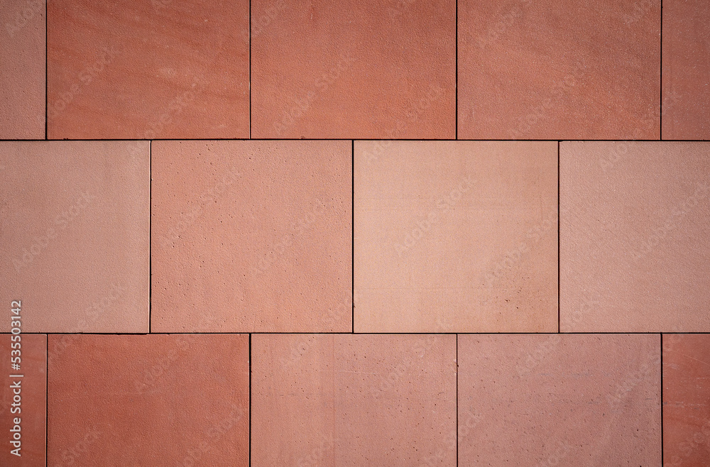 Naklejka premium texture of a red stone wall facade