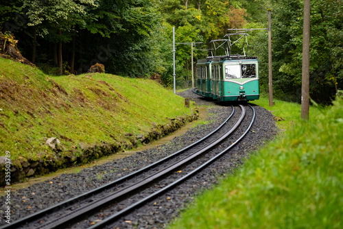 Historic Rack Railway on a curved sloping track in Königswinter Germany. Old electric train climbing upwards to the “Drachenfels“, a popular tourist attraction near Bonn in the romantic Rhine valley.
