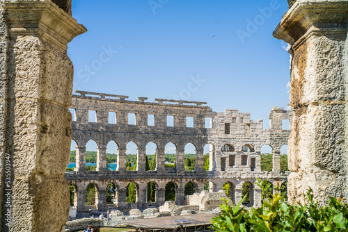 Roman amphitheater in the city of Pula, Croatia. Close-ups on the ancient walls of a Roman building. A beautiful sunny day with fairy-tale clouds in the background photo