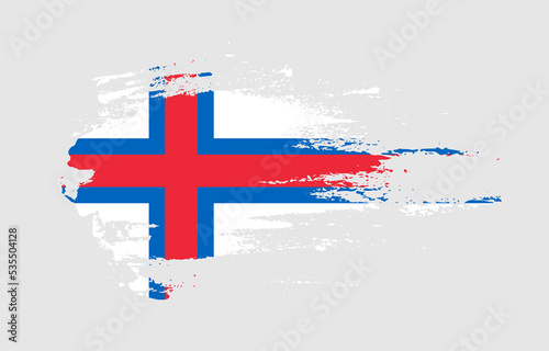 Grunge brush stroke flag of Faroe Islands with painted brush splatter effect on solid background