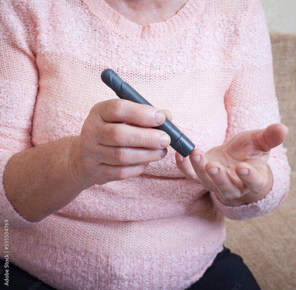 Senior woman checking blood sugar level using glucometer. Closeup hand of old person with diabetes. Diabetes treatment for elderly people. Senior woman checking blood sugar level using glucometer. Closeup hand of old person with diabetes. Diabetes treatment for elderly people.
