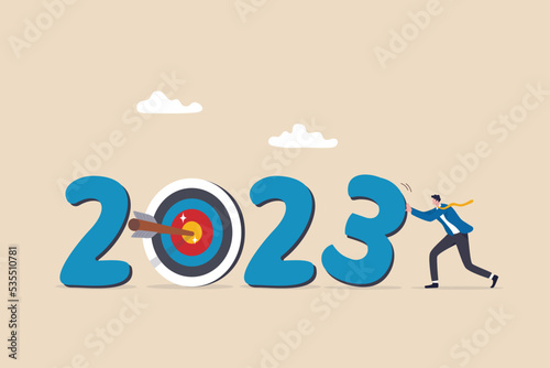Year 2023 business target, new year resolution or challenge to achieve goal, aim for business success, growth or motivation to succeed concept, businessman changing year to 2023 target.