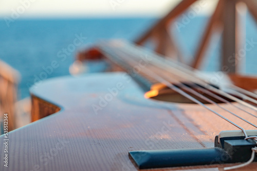 classical guitar close-up with the sea in the background photo