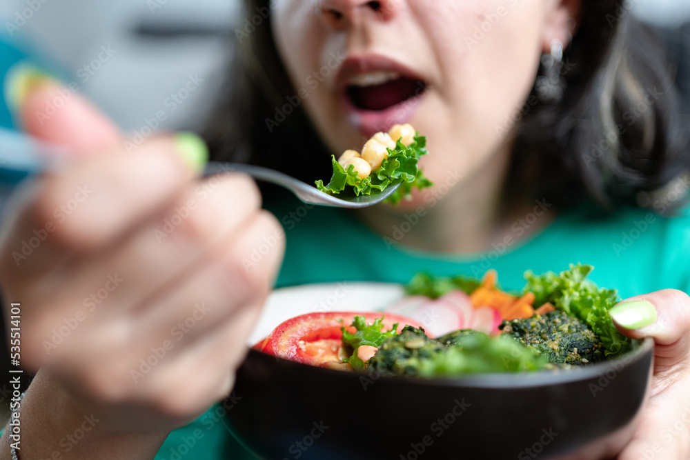 Woman eating veggie lunch. Vegetarian and plant based food concept. Selective focus, Woman eating veggie lunch. Vegetarian and plant based food concept. Selective focus,