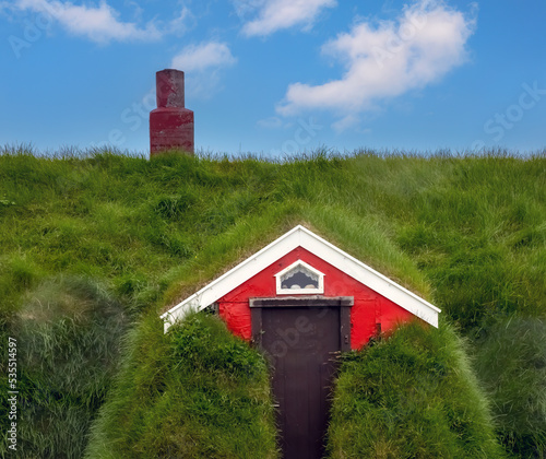 The charming village and church of Borgarfjörður eystri with historic turf-roofed houses, Eastern Iceland photo