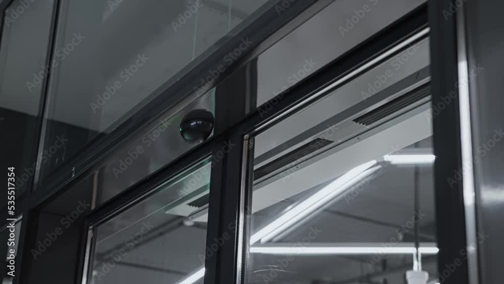 Sliding automatic glass doors open and close at entrance to building. Exit from Business office or bank. Hall of shopping center. Inside mall store. Hotel resort Sliding automatic glass doors open and close at entrance to building. Exit from Business office or bank. Hall of shopping center. Inside mall store. Hotel resort