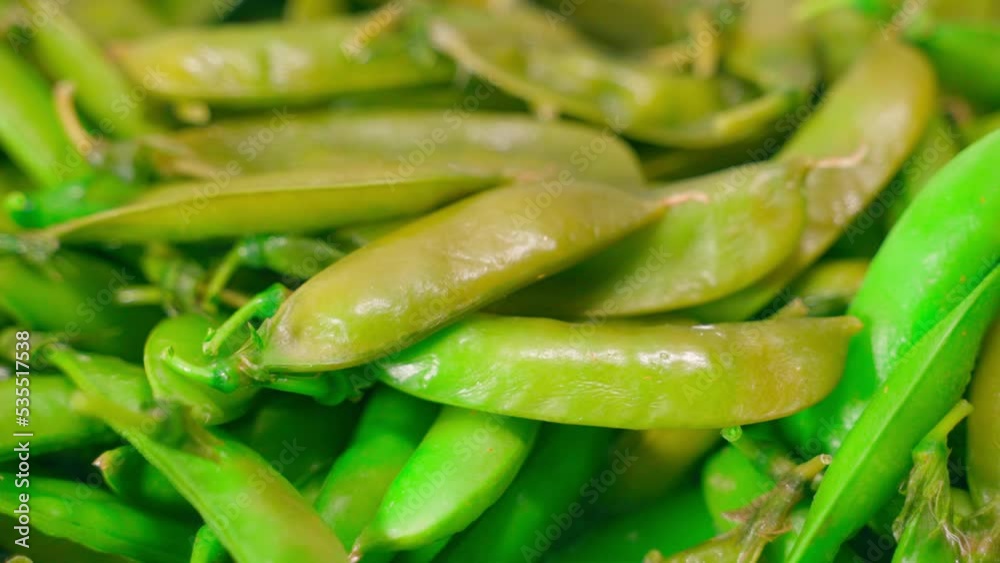 Green peas boiled in a peel close-up. Preparing young freshly picked green peas Cooking vegetables before eating Green peas boiled in a peel close-up. Preparing young freshly picked green peas Cooking vegetables before eating