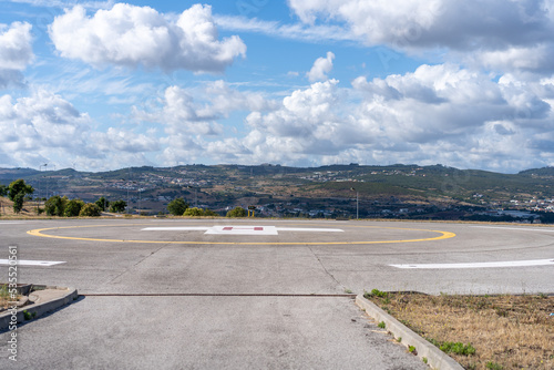 Helipad. Helicopter Landing Pad near emergency hospital in Portugal with cloud sky and city on background