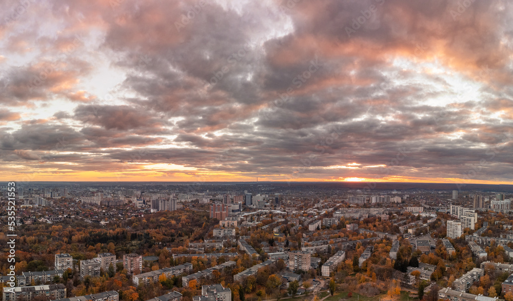 Aerial evening warm colorful view on Kharkiv city Pavlove Pole district. Multistory buildings residential in autumn sunset light