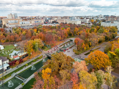 Aerial view on vibrant autumn Shevchenko City Garden with fountains. Tourist attraction in colorful park in Kharkiv, Ukraine