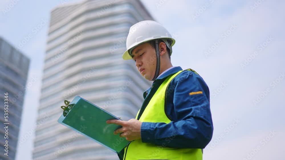young man technician working with clipboard in
construction site near modern building young man technician working with clipboard in
construction site near modern building
