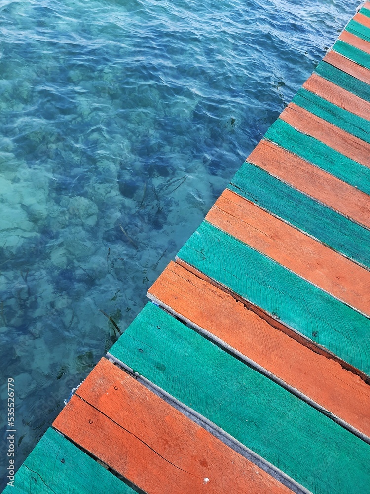 Wooden floor with sea water background