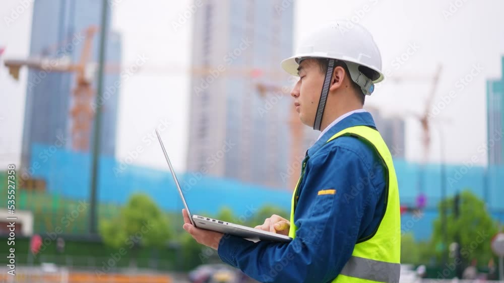 young man technician working with laptop construction site near modern building young man technician working with laptop construction site near modern building