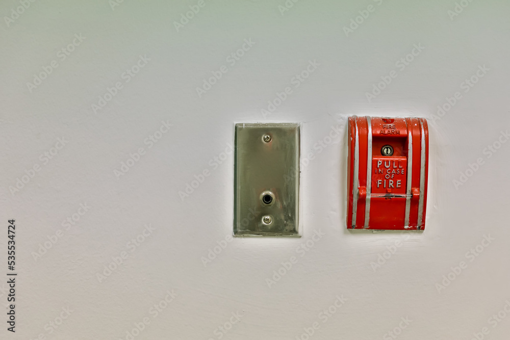 Fire alarm on the wall. Emergency of Fire alarm or alert or bell warning equipment. Fire alarm box on cement wall for warning and security system in the condominium place. 