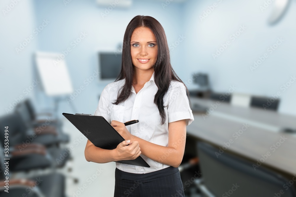 Happy businesswoman working with clipboard.