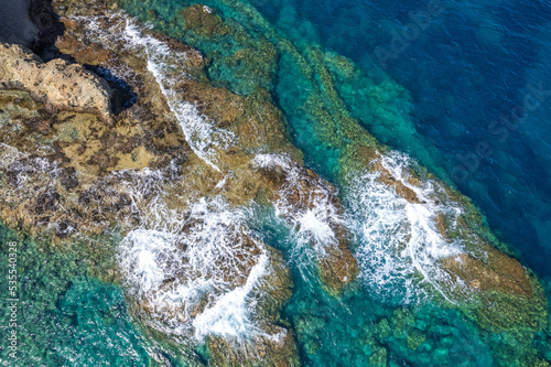 Aerial view of crashing waves on rocks landscape nature view. Sea coast view in summer season image by Drone High angle view.