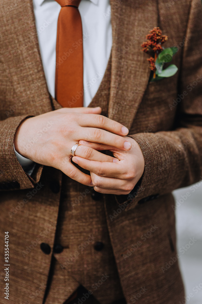 Fototapeta premium The groom puts a gold ring on his finger at the ceremony, worrying. Close-up wedding photography, portrait.