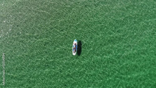Wallpaper Mural Aerial view from drone: young attractive woman in bikini and sunglasses floating on paddle board on turquoise water Torontodigital.ca