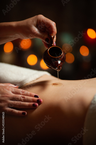 Professional massege woman client working at spa center. Young beautiful woman relaxing during full body massage at luxury resort wellness wellbeing pampering skin