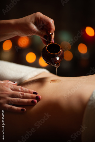 Professional massege woman client working at spa center. Young beautiful woman relaxing during full body massage at luxury resort wellness wellbeing pampering skin