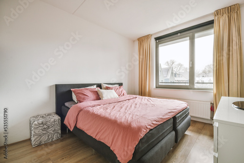 Soft bed and nightstand in modern light bedroom