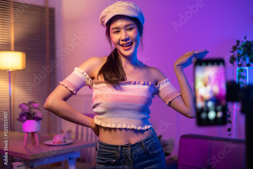 Asian young beautiful woman streamer listening to music dancing and listening music at Home Interior, Residential Building.
