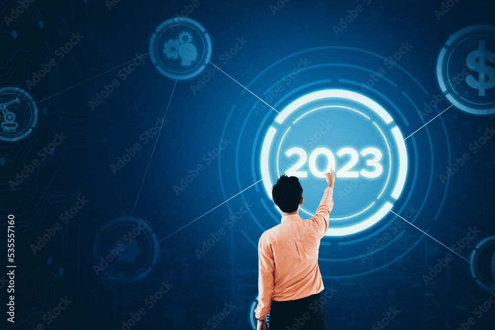Businessman touch 2023 button on virtual screen Businessman touch 2023 button on virtual screen