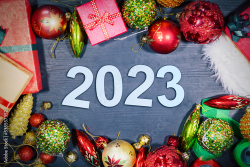 Christmas ornaments with 2023 numbers on table © Creativa Images