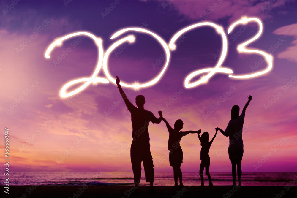 Happy family celebrating new year of 2023 on beach Happy family celebrating new year of 2023 on beach