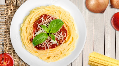 Hot tasty spaghetti dish with sauce in plate.