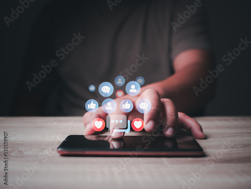 Man hand touching the smartphone, Social media, and digital online concept, playing social media. chatting application and social network app. Social media application chat box icon